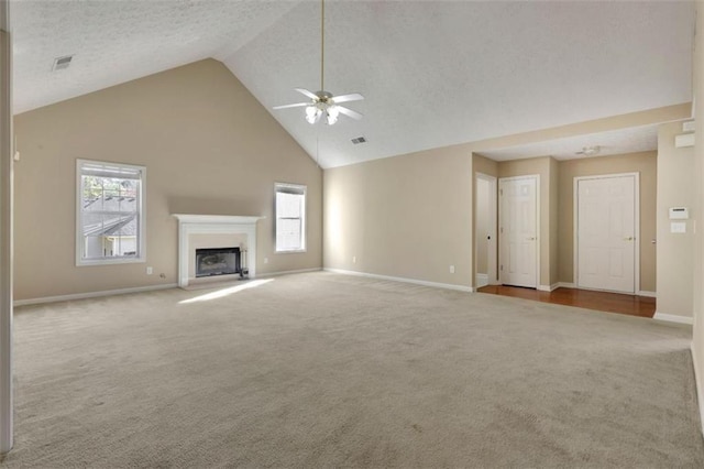 unfurnished living room featuring light carpet, high vaulted ceiling, ceiling fan, and a textured ceiling