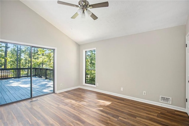empty room featuring ceiling fan, high vaulted ceiling, baseboards, wood finished floors, and visible vents