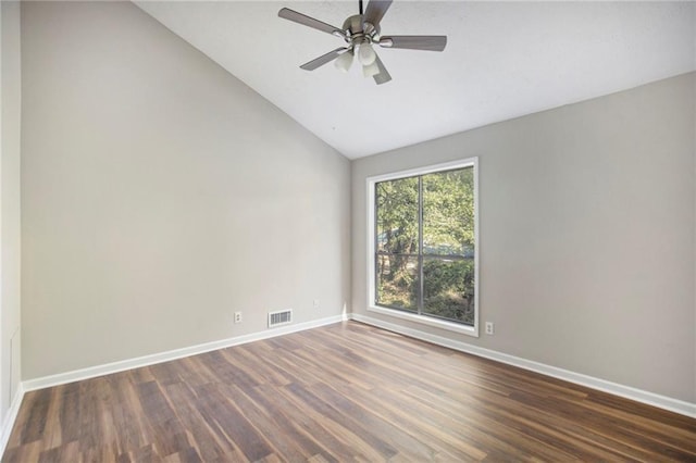 empty room featuring baseboards, visible vents, wood finished floors, and lofted ceiling