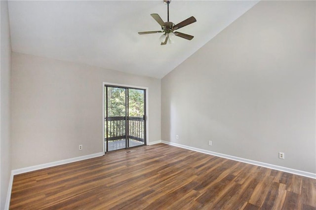 spare room featuring baseboards, dark wood finished floors, ceiling fan, and vaulted ceiling