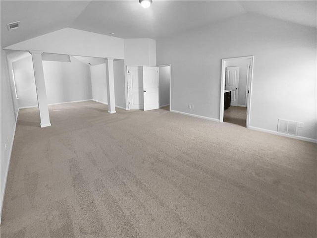 additional living space featuring lofted ceiling, carpet flooring, visible vents, and ornate columns