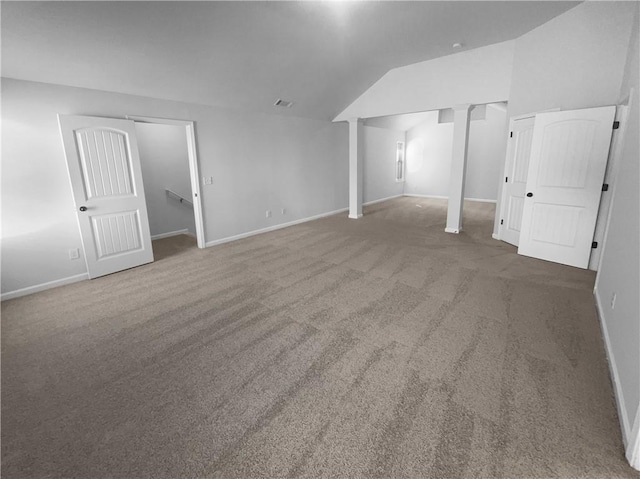 interior space with lofted ceiling, carpet floors, visible vents, and baseboards