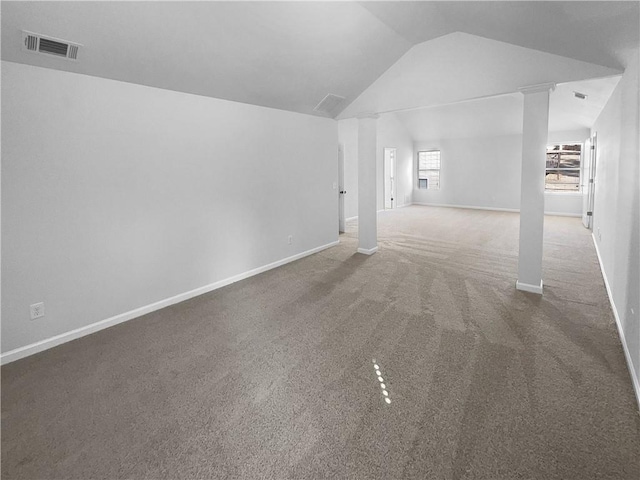 interior space with lofted ceiling, ornate columns, baseboards, and visible vents