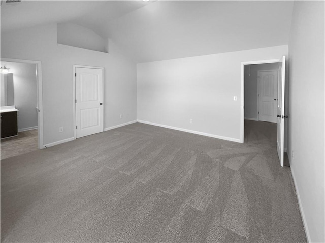 interior space with lofted ceiling, baseboards, and carpet floors