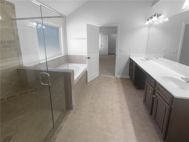 full bathroom featuring tile patterned flooring, a sink, vaulted ceiling, a shower stall, and a bath