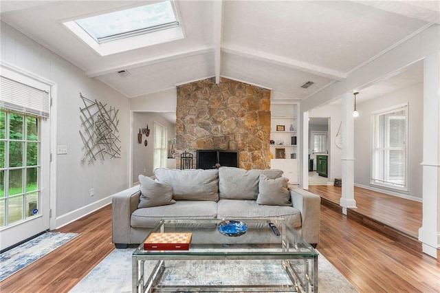 1328 Hidden Hills Pkwy, Stone Mountain, GA 30088 - living room featuring wood finished floors, a fireplace, and a skylight