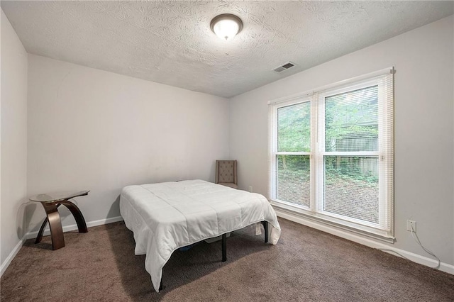 1328 Hidden Hills Pkwy, Stone Mountain, GA 30088 - carpeted bedroom featuring a textured ceiling and baseboards
