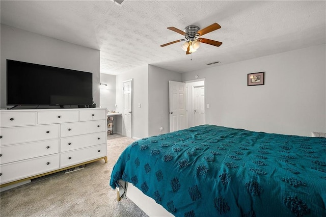 1328 Hidden Hills Pkwy, Stone Mountain, GA 30088 - bedroom featuring light carpet, a textured ceiling, ensuite bath, and a ceiling fan