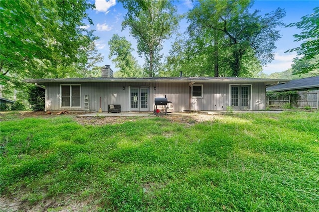 1328 Hidden Hills Pkwy, Stone Mountain, GA 30088 - back of property featuring french doors, a chimney, and board and batten siding