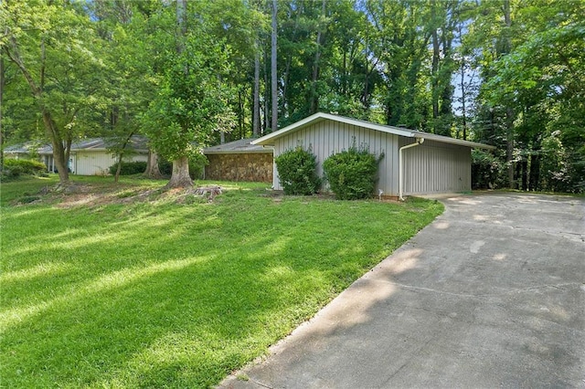 1328 Hidden Hills Pkwy, Stone Mountain, GA 30088 - view of front facade featuring a front yard, concrete driveway, board and batten siding, and view of wooded area