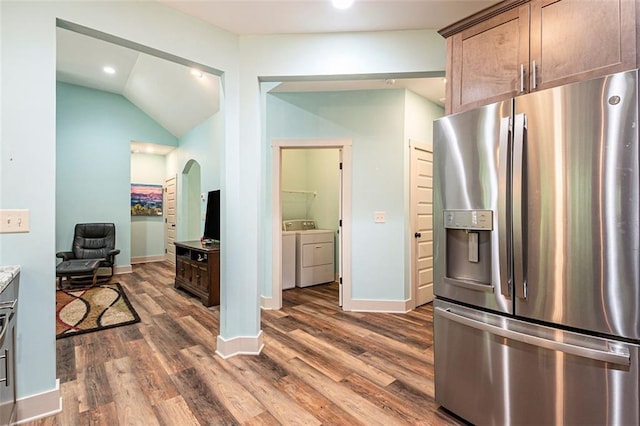 562 Yonah Lake Dr, Sautee Nacoochee, GA 30572 - kitchen featuring stainless steel fridge with ice dispenser, independent washer and dryer, arched walkways, dark wood-style flooring, and lofted ceiling