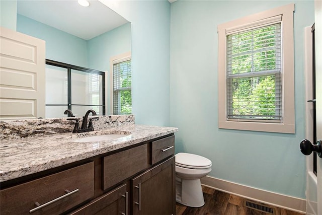 562 Yonah Lake Dr, Sautee Nacoochee, GA 30572 - full bath featuring wood finished floors, vanity, a shower with shower door, baseboards, and toilet