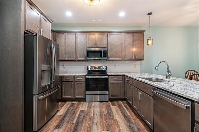 562 Yonah Lake Dr, Sautee Nacoochee, GA 30572 - kitchen featuring appliances with stainless steel finishes, a sink, dark wood finished floors, decorative backsplash, and light stone countertops