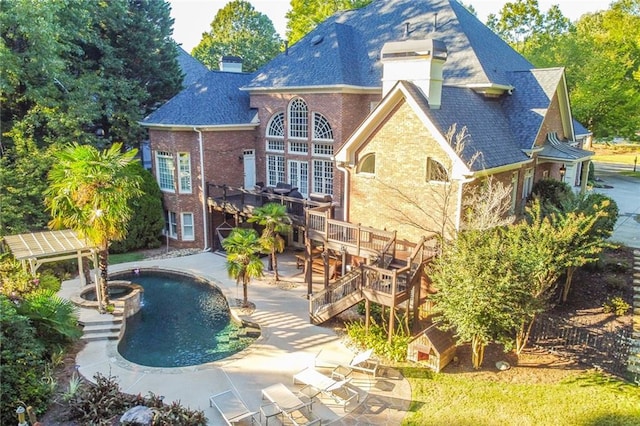 back of house featuring a patio and a pool side deck