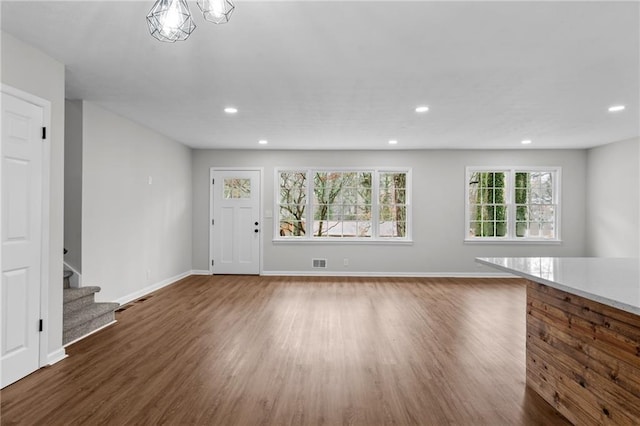 unfurnished living room featuring dark hardwood / wood-style floors