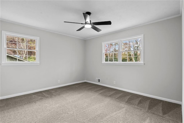 carpeted spare room with ornamental molding, a healthy amount of sunlight, and ceiling fan