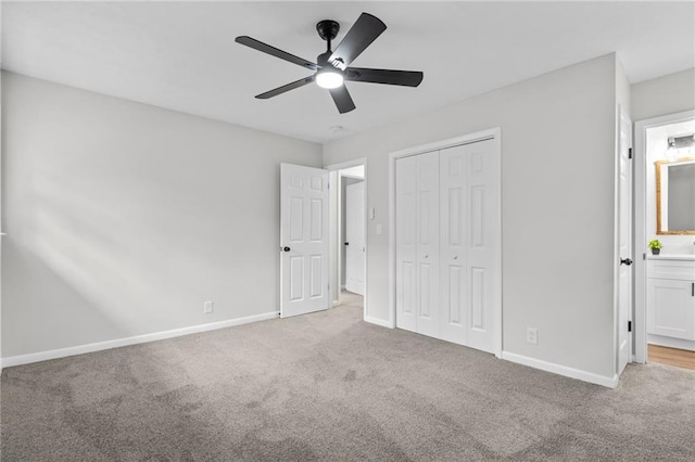 unfurnished bedroom with light colored carpet, a closet, and ceiling fan