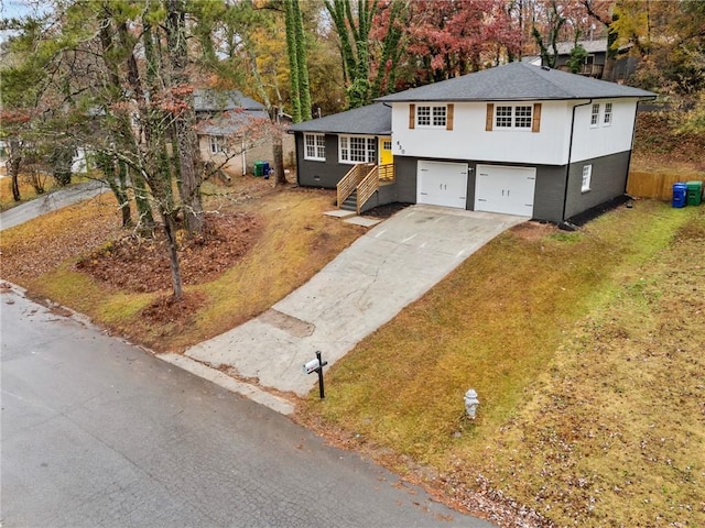 view of front of house with a garage and a front yard