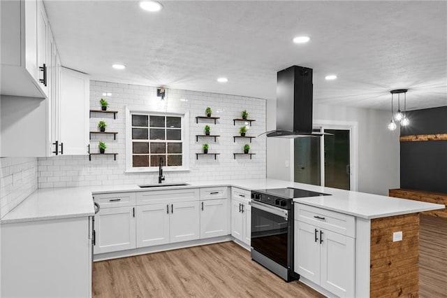 kitchen with white cabinetry, decorative light fixtures, stainless steel range with electric cooktop, and island exhaust hood