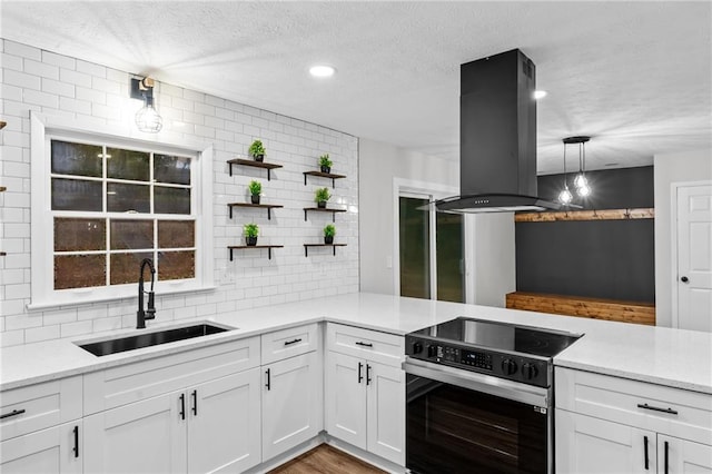 kitchen featuring island exhaust hood, sink, white cabinets, and electric stove