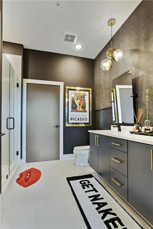 112 Rogers St NE Unit 505, Atlanta, GA 30317 - full bath with vanity, toilet, a shower stall, and tile patterned floors