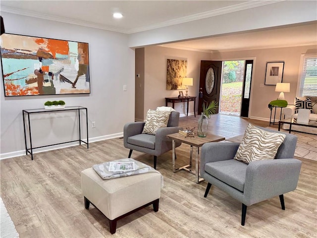 living area featuring light wood-type flooring and crown molding