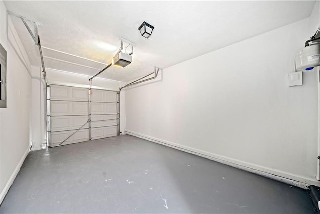 garage featuring baseboards and a garage door opener