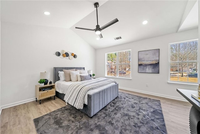 bedroom featuring visible vents, lofted ceiling, baseboards, and wood finished floors