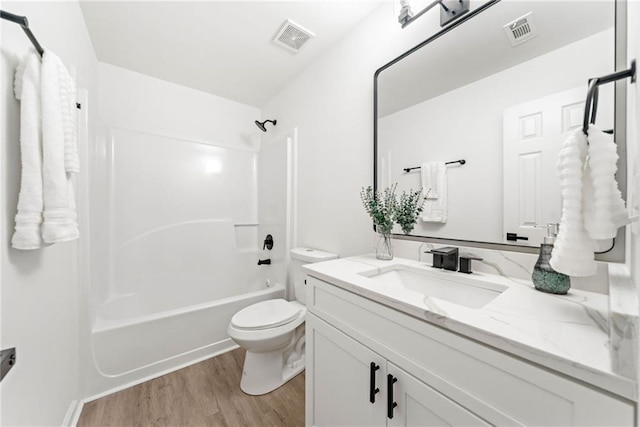 full bathroom featuring visible vents, toilet, wood finished floors, and vanity