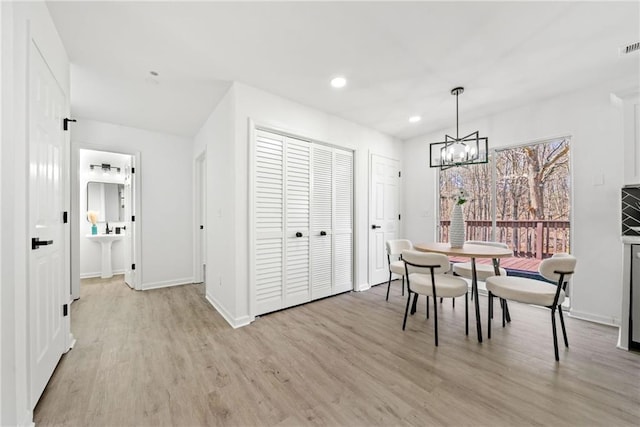 dining area featuring visible vents, baseboards, light wood-style flooring, recessed lighting, and a notable chandelier