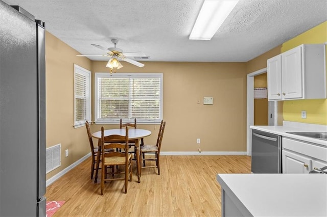 305 Hickory Pointe Ct, Villa Rica, GA 30180 - dining room featuring light wood-style floors, a ceiling fan, and a textured ceiling