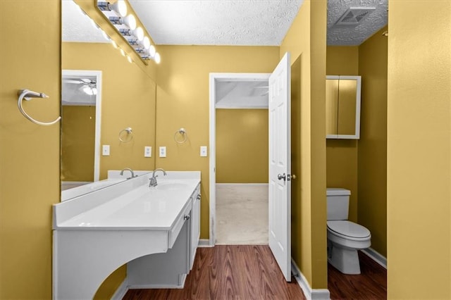 305 Hickory Pointe Ct, Villa Rica, GA 30180 - bathroom with wood finished floors, vanity, a textured ceiling, and a ceiling fan