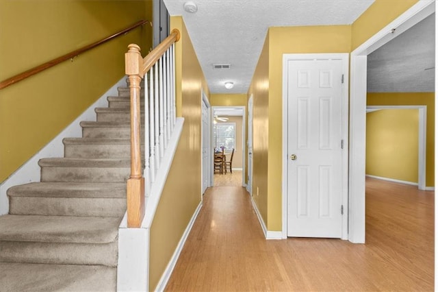 305 Hickory Pointe Ct, Villa Rica, GA 30180 - staircase featuring wood finished floors and a textured ceiling