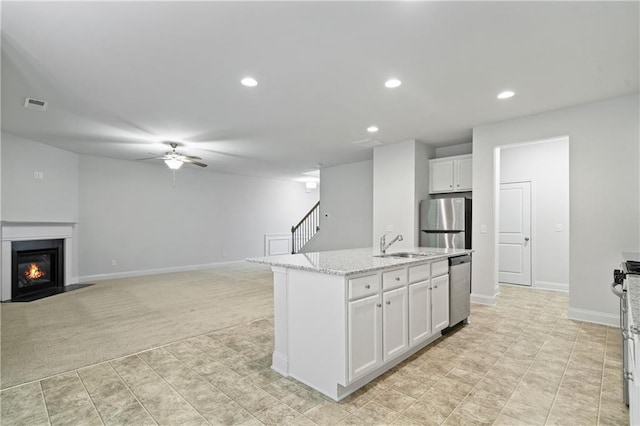 61 Castlemoor Loop, Adairsville, GA 30103 - kitchen featuring a ceiling fan, stainless steel appliances, a premium fireplace, white cabinets, and visible vents