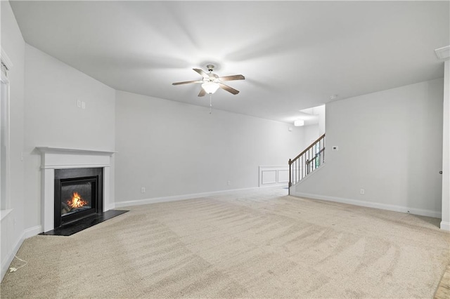 61 Castlemoor Loop, Adairsville, GA 30103 - unfurnished living room featuring stairs, a fireplace with flush hearth, ceiling fan, baseboards, and carpet flooring