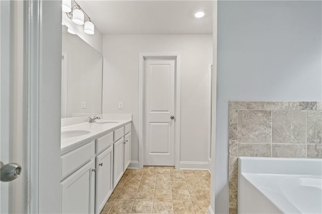 61 Castlemoor Loop, Adairsville, GA 30103 - bathroom with a garden tub, a sink, double vanity, and baseboards