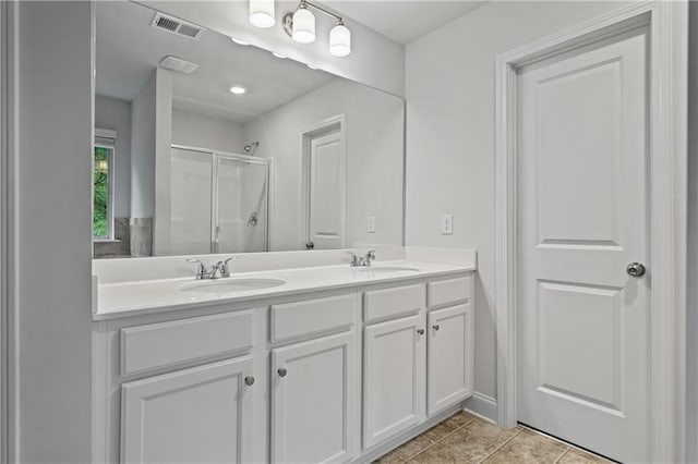 61 Castlemoor Loop, Adairsville, GA 30103 - bathroom with visible vents, a sink, a shower stall, and double vanity