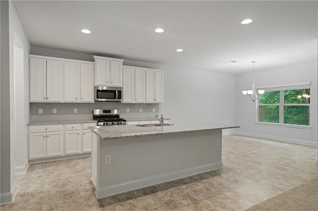 61 Castlemoor Loop, Adairsville, GA 30103 - kitchen featuring stainless steel appliances, a sink, an inviting chandelier, white cabinetry, and light stone countertops