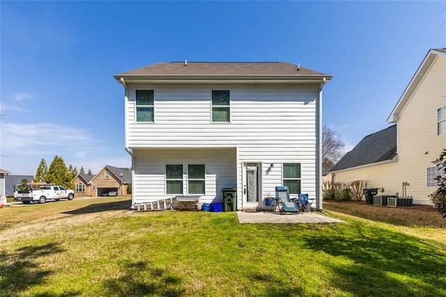 rear view of property featuring a lawn and a patio area