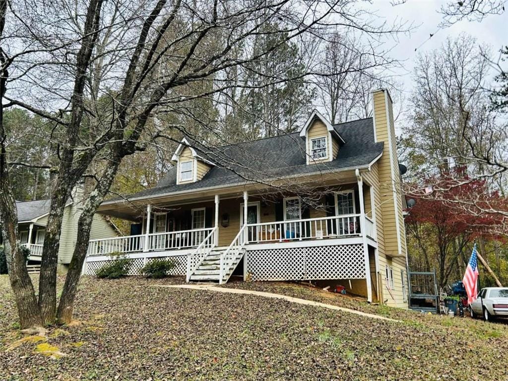 new england style home featuring covered porch