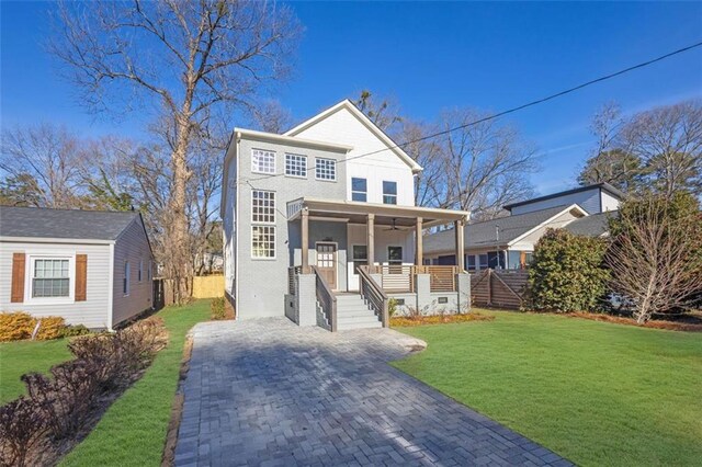 view of front of home featuring covered porch and a front lawn