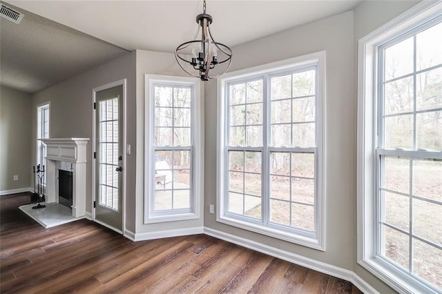 entryway with dark hardwood / wood-style flooring and a notable chandelier