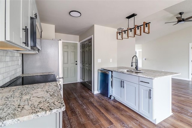 kitchen featuring pendant lighting, dark wood-type flooring, stainless steel dishwasher, ceiling fan, and white cabinetry