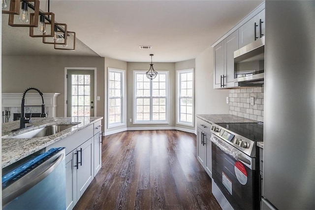 kitchen with dark wood-type flooring, sink, white cabinets, and stainless steel appliances