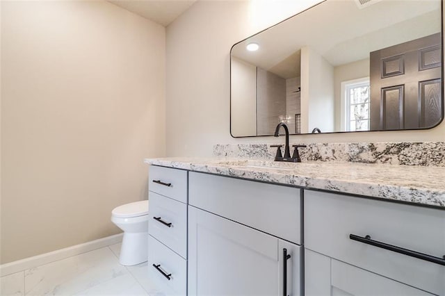 bathroom with vanity and toilet