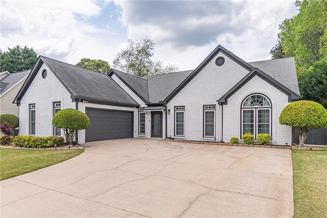 220 Chandler Ct, Sugar Hill, GA 30518 - view of front of house with brick siding, concrete driveway, a garage, and a front yard