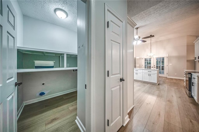 220 Chandler Ct, Sugar Hill, GA 30518 - laundry room with a textured ceiling, light wood-type flooring, ceiling fan, and french doors