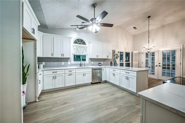 220 Chandler Ct, Sugar Hill, GA 30518 - kitchen featuring stainless steel dishwasher, a peninsula, white cabinets, ceiling fan, and light wood-style flooring