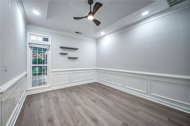 220 Chandler Ct, Sugar Hill, GA 30518 - empty room featuring crown molding, a textured ceiling, a ceiling fan, wood finished floors, and wainscoting