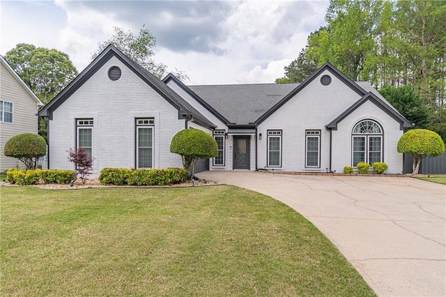 220 Chandler Ct, Sugar Hill, GA 30518 - view of front facade with brick siding, a front lawn, and driveway